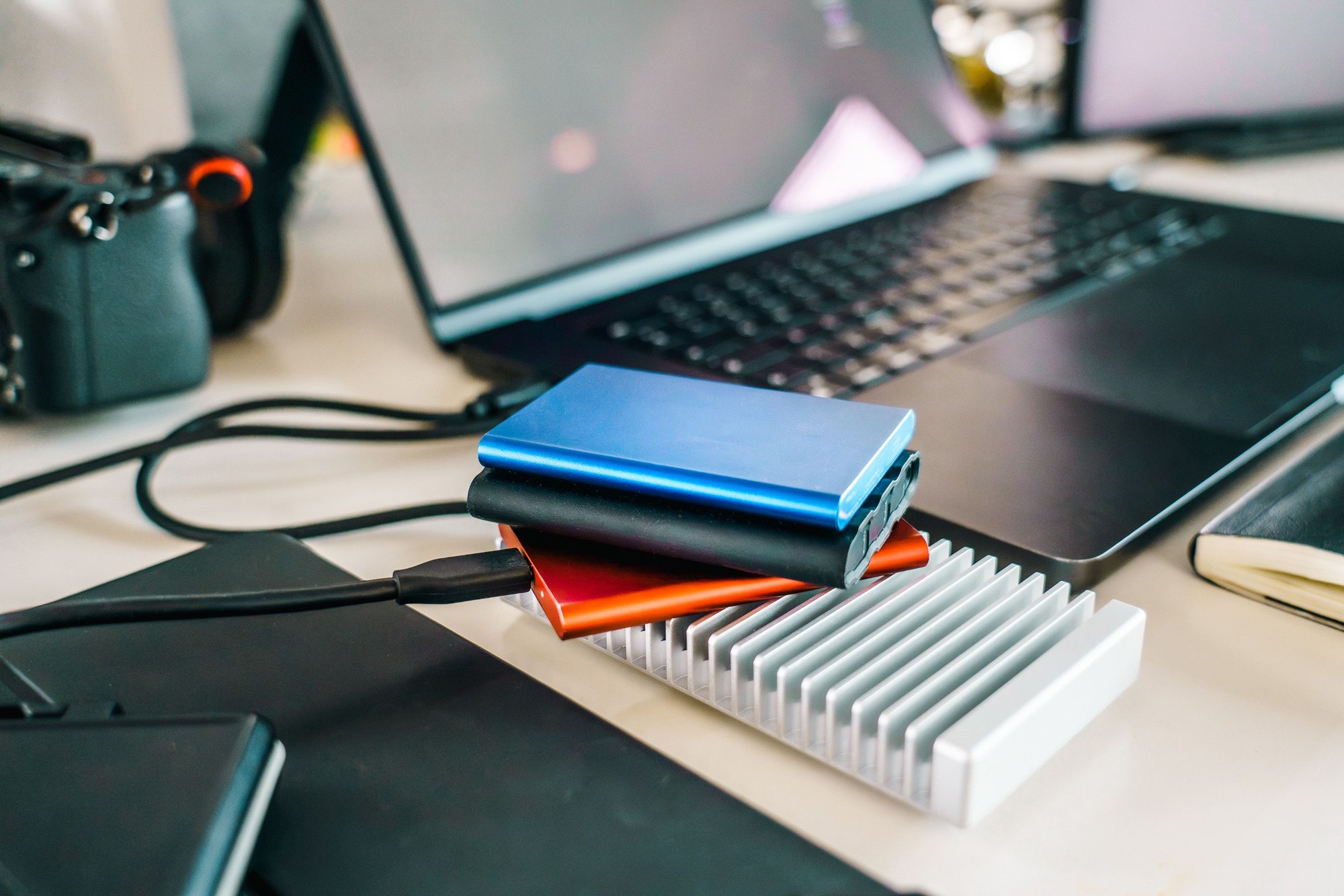 Concept visual: external drives, camera and laptop